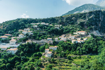 Fototapeta na wymiar The stunning mountain town of Dhermi, stuck in the middle of Albanian alps and your houses with dozens of windows, Albania. 