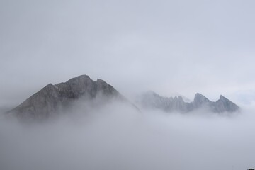 View of a mountain with clouds below