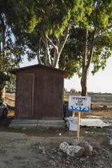 Vertical shot of a sign in spanish next to a dry lake translating to 'take care of me I am life'
