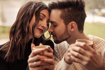 Heterosexual couple have a date and celebrate it in vegetarian restaurant. Drinking coffee and...