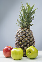 fruits in an arrangement on a white wooden surface with a white background. selective focus.