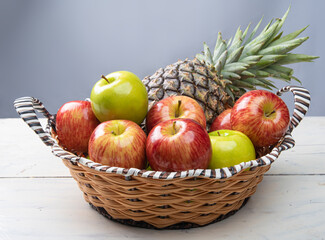 fruits in an arrangement on a white wooden surface with a white background. selective focus.