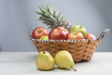 fruits in an arrangement on a white wooden surface with a white background. selective focus.