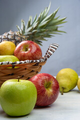 fruits in an arrangement on a white wooden surface with a white background. selective focus.