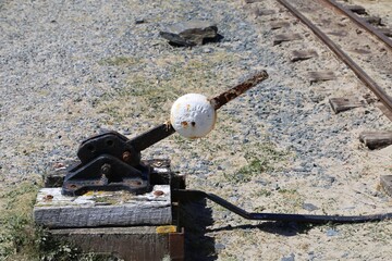 A closeup view of a points lever on a narrow gauge railway line. 