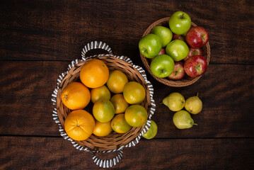 fruits arranged on a rustic wooden surface with a black background. selective focus.