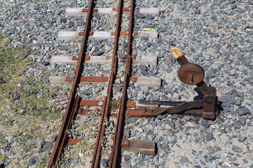 A closeup view of the tracks and points on a narrow gauge railway line. 