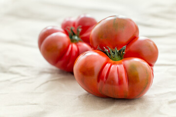 Two red ripe tomatoes. Heirloom, Brandywine, Spanish Raf tomato from local organic farmer's market.