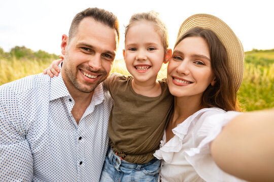 Happy family taking selfie on a picnic outdoor