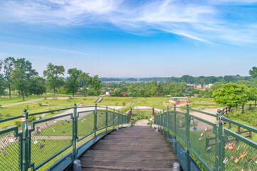 Panoramic view on Zamosc on skyway bridge with love padlocks over railroad tracks.