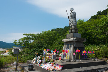 Fototapeta na wymiar Jizo Bosatsu Statue at Osorezan Bodaiji Temple in Mutsu, Aomori, Japan. founded in 862 AD by the famed monk Ennin, a famous historic site.
