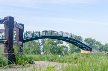 Public skywalk bridge with love padlocks over railroad tracks.