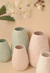 artificial flowers in decorative vase on beige background