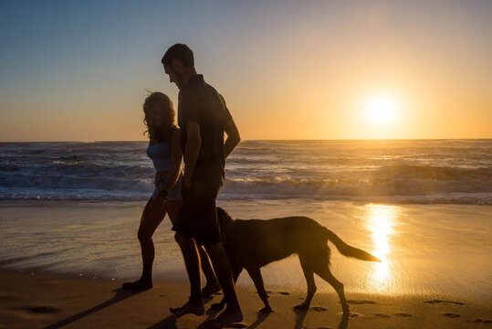 young couple in love in the evening on the beach