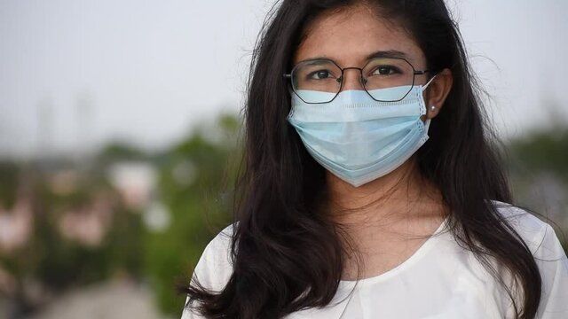 Portrait of a young Indian girl wearing medical mask to protect herself from the Coronavirus during the pandemic