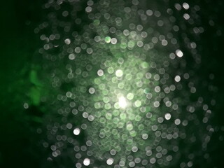 green  blurred background  wit many white colour bubbled are show.