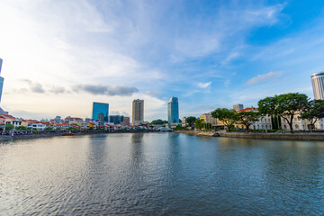 An array of multi-storey buildings in the middle of the field with river on sky background in singapore city. decoration image contain certain grain noise and soft focus.