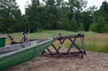 Fishing boat on the background of the forest