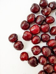 Bright ripe juicy cherry on a white background. A place for text.