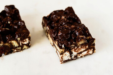 Raw Chocolate Hazelnut cake slices on white marble background. Selective focus