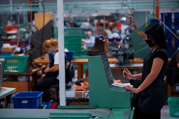 Shoe making process in footwear factory.