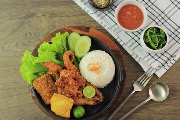Ayam Taliwang is Lombok's Special Food, Made from Young Smoked Chicken, Spiced and Grill with Chilli Sauce. Served with Plecing Kangkung (Water Spinach) and Rice