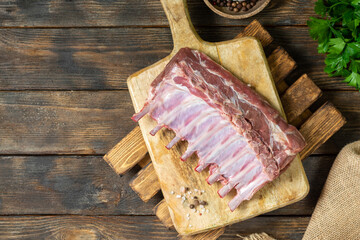 Lamb meat. Lamb ribs on a wooden chopping Board on a brown wooden table. Raw lamb meat on the table, loin