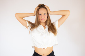 Beautiful young girl in white shirt angry