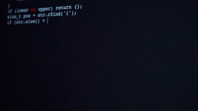 Encrypted fast long typing programming security hacking code on black display.