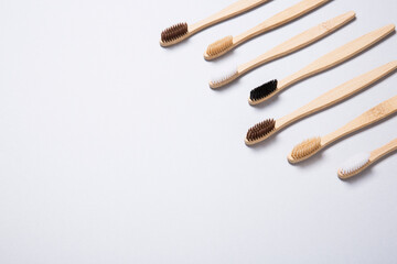 Bamboo toothbrushes arranged on grey background