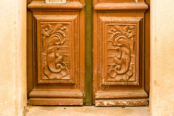 carved old wooden door in Olhao, Portugal