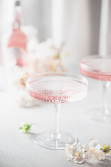 Homemade pink vodka cosmopolitan cocktail drink in crystal glasses