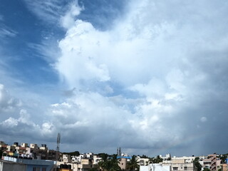 Rainbow and blue clouds and sky in the city