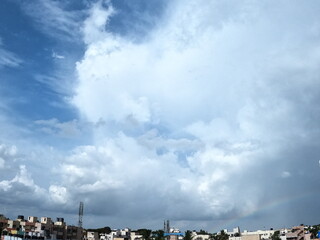 Rainbow and blue clouds and sky in the city