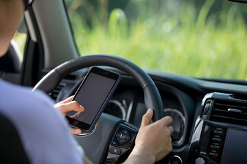 Woman driver using smartphone while driving a off road car in the nature