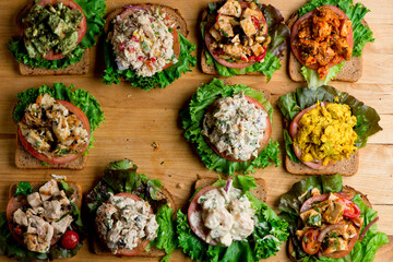 Sandwiches. Tuna Salad. Chicken Salad. Served on slices of white, rye, and whole grain bread with lettuce and tomato. Traditional American lunch or snack favorite. 