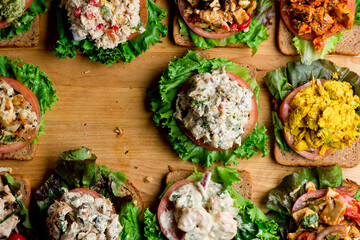 Sandwiches. Tuna Salad. Chicken Salad. Served on slices of white, rye, and whole grain bread with lettuce and tomato. Traditional American lunch or snack favorite. 