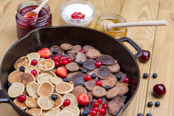Frying pan with cereal pancakes. Flour, berry yogurt, butter, honey jam. Healthy Diet Snack. Close up

