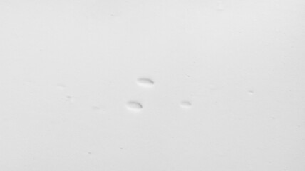 White cosmetic foam bubbles texture background. Creamy mousse, cleanser, shaving foam, shampoo lather flat surface