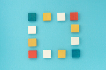 frame of multi-colored wooden squares on a blue background.