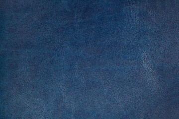 Genuine leather texture  dark blue color. Leather surface. Close up. Copy space.