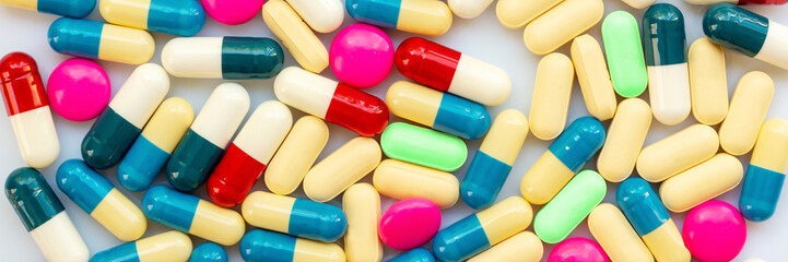 Panoramic background of colorful pills and medication, health and medication concept