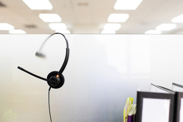 VOIP headset for callcenter on desk at customer service office. Communication support for sale support and telemaketing Helpdeskac