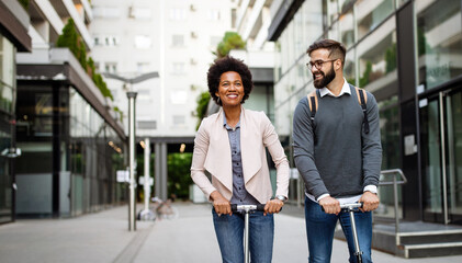 Happy young couple enjoying together while riding electric scooters on city street