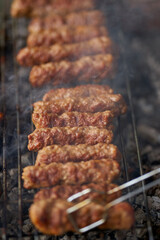 Minced pork rolls on barbecue