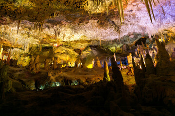 Stalactite caves in Spain on the island of Mallorca. Caves are available for excursions. Multi-colored illumination of caves. Beautiful cave.