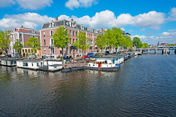 Fototapeta premium City scenic from Amsterdam at the river Amstel in the Netherlands