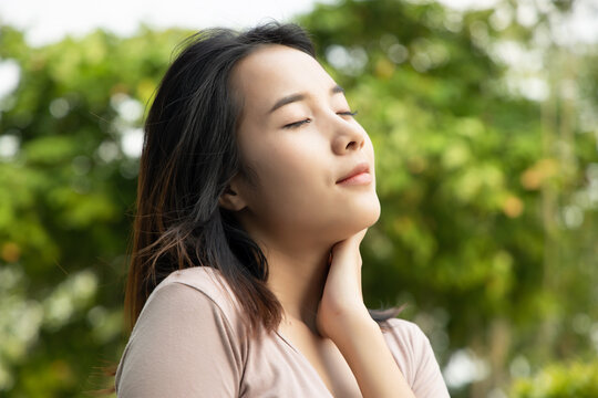 Happy relaxed woman breathing fresh air in green environment