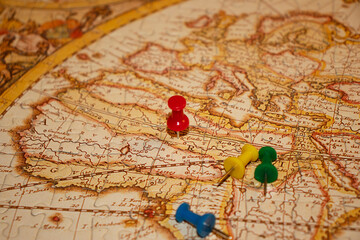 Colorful pins on vintage jigsaw puzzle map