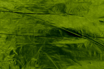 Texture of green crumpled paper background.